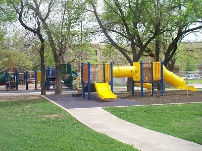 Playscape with bright yellow slides.