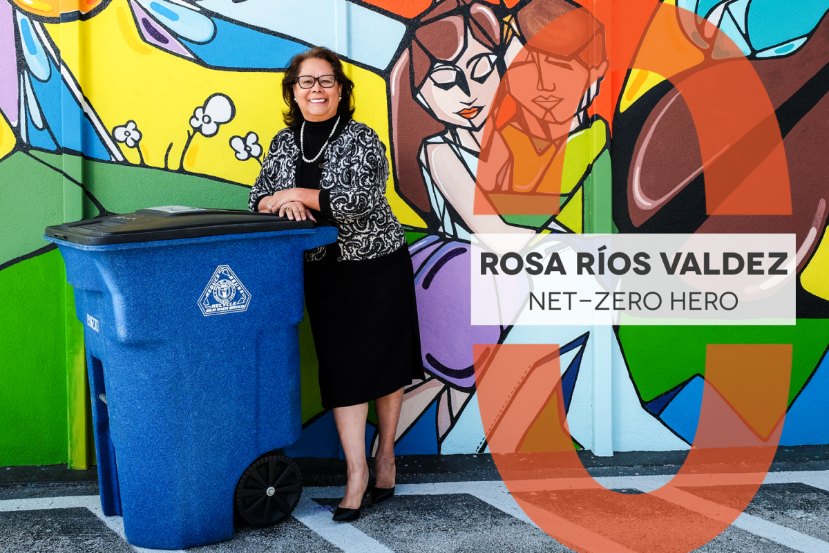 Net-Zero Hero Rosa Ríos Valdez, Rosa is pictured leaning on a recycling bin with a colorful mural behind her.